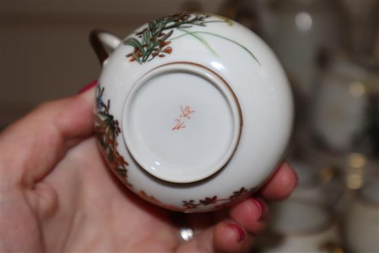 A Japanese Satsuma part coffee service, decorated with flowers and heightened in gilt, comprising coffee pot, cream jug,